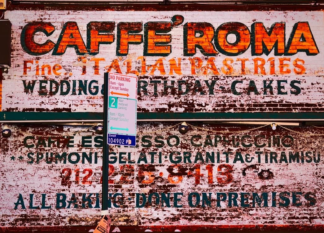 Verwittertes farbiges Schild eines italienischen Cafés